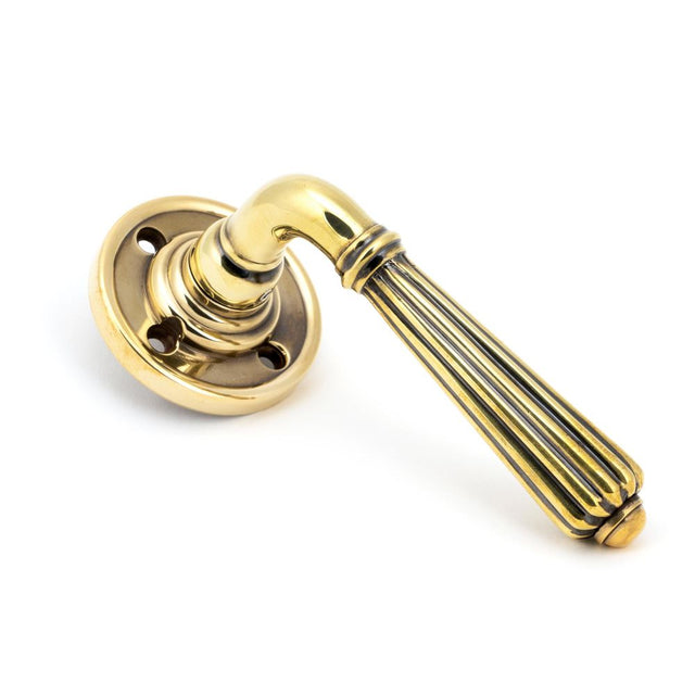 This is an image of From The Anvil - Aged Brass Hinton Lever on Rose Set - Unsprung available to order from T.H Wiggans Architectural Ironmongery in Kendal, quick delivery and discounted prices.