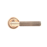 This is an image showing From The Anvil - Polished Bronze Brompton Lever on Rose Set (Art Deco) - Unsprun available from trade door handles, quick delivery and discounted prices