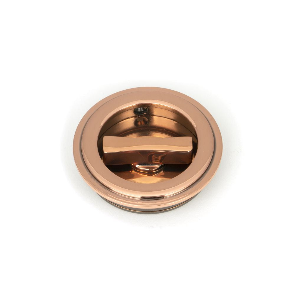 This is an image showing From The Anvil - Polished Bronze 60mm Art Deco Round Pull - Privacy Set available from trade door handles, quick delivery and discounted prices