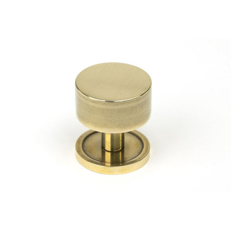 This is an image showing From The Anvil - Aged Brass Kelso Cabinet Knob - 32mm (Plain) available from T.H Wiggans Architectural Ironmongery in Kendal, quick delivery and discounted prices