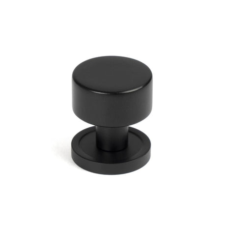 This is an image showing From The Anvil - Matt Black Kelso Cabinet Knob - 25mm (Plain) available from T.H Wiggans Architectural Ironmongery in Kendal, quick delivery and discounted prices