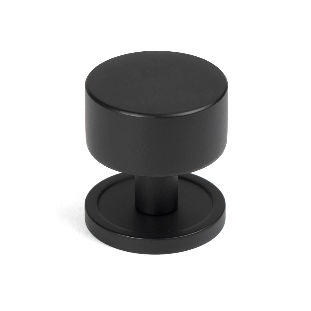 This is an image showing From The Anvil - Matt Black Kelso Cabinet Knob - 32mm (Plain) available from T.H Wiggans Architectural Ironmongery in Kendal, quick delivery and discounted prices