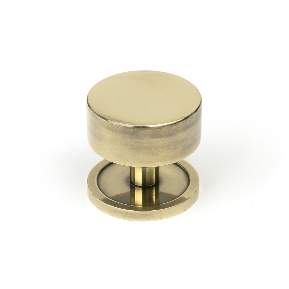 This is an image showing From The Anvil - Aged Brass Kelso Cabinet Knob - 38mm (Plain) available from T.H Wiggans Architectural Ironmongery in Kendal, quick delivery and discounted prices