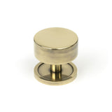 This is an image showing From The Anvil - Aged Brass Kelso Cabinet Knob - 38mm (Plain) available from T.H Wiggans Architectural Ironmongery in Kendal, quick delivery and discounted prices
