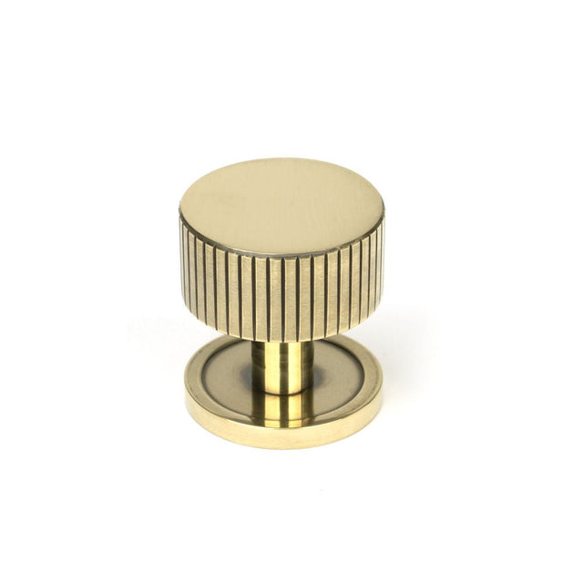 This is an image showing From The Anvil - Aged Brass Judd Cabinet Knob - 32mm (Plain) available from T.H Wiggans Architectural Ironmongery in Kendal, quick delivery and discounted prices