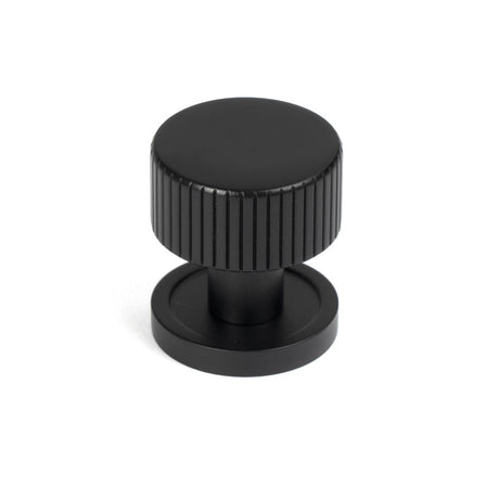 This is an image showing From The Anvil - Matt Black Judd Cabinet Knob - 25mm (Plain) available from T.H Wiggans Architectural Ironmongery in Kendal, quick delivery and discounted prices