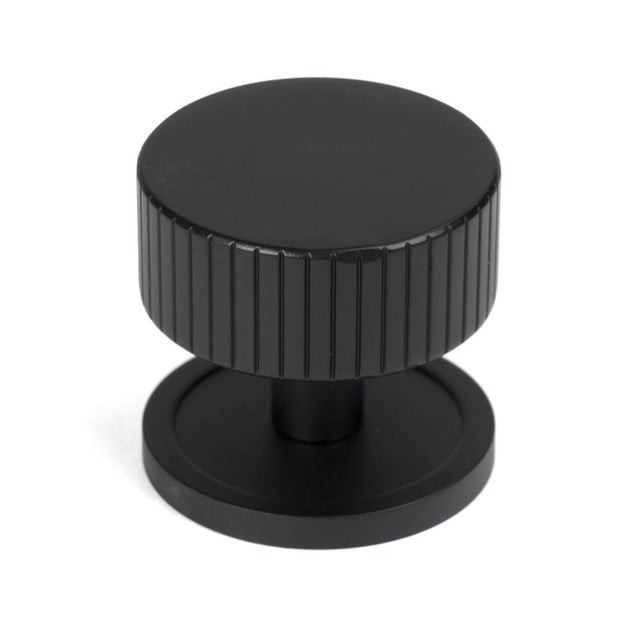 This is an image showing From The Anvil - Matt Black Judd Cabinet Knob - 38mm (Plain) available from T.H Wiggans Architectural Ironmongery in Kendal, quick delivery and discounted prices