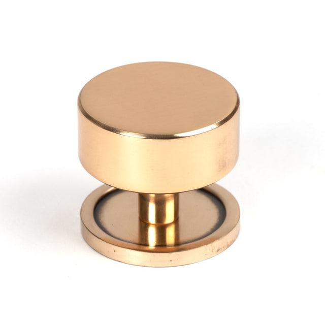 This is an image showing From The Anvil - Polished Bronze Kelso Cabinet Knob - 38mm (Plain) available from T.H Wiggans Architectural Ironmongery in Kendal, quick delivery and discounted prices