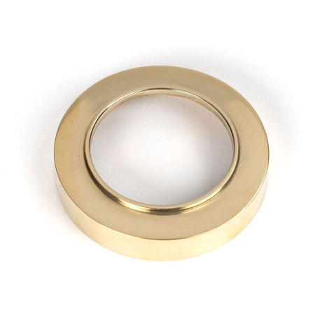 This is an image showing From The Anvil - Polished Brass Round Euro Escutcheon (Plain) available from trade door handles, quick delivery and discounted prices