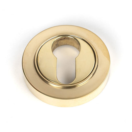 This is an image of From The Anvil - Polished Brass Round Euro Escutcheon (Plain) available to order from T.H Wiggans Architectural Ironmongery in Kendal, quick delivery and discounted prices.