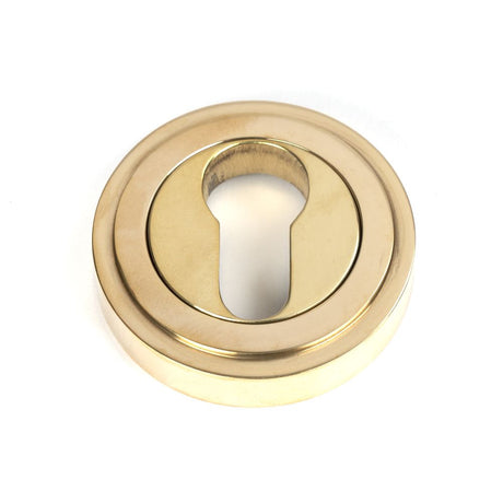 This is an image of From The Anvil - Polished Brass Round Euro Escutcheon (Art Deco) available to order from T.H Wiggans Architectural Ironmongery in Kendal, quick delivery and discounted prices.