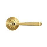 This is an image showing From The Anvil - Polished Brass Avon Round Lever on Rose Set (Beehive) available from trade door handles, quick delivery and discounted prices