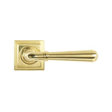 This is an image showing From The Anvil - Polished Brass Newbury Lever on Rose Set (Square) available from trade door handles, quick delivery and discounted prices