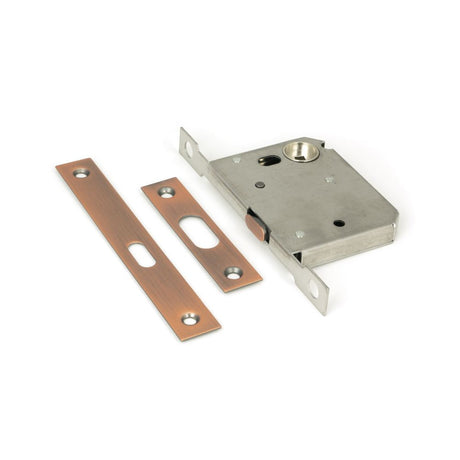 This is an image showing From The Anvil - Polished Bronze 50mm Sliding Door Lock available from T.H Wiggans Architectural Ironmongery in Kendal, quick delivery and discounted prices