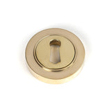 This is an image of From The Anvil - Polished Brass Round Escutcheon (Plain) available to order from T.H Wiggans Architectural Ironmongery in Kendal, quick delivery and discounted prices.