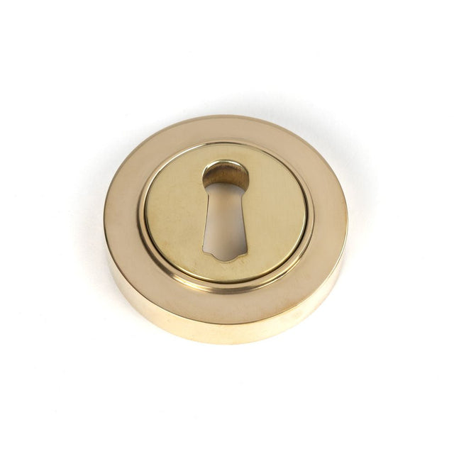 This is an image of From The Anvil - Polished Brass Round Escutcheon (Plain) available to order from T.H Wiggans Architectural Ironmongery in Kendal, quick delivery and discounted prices.