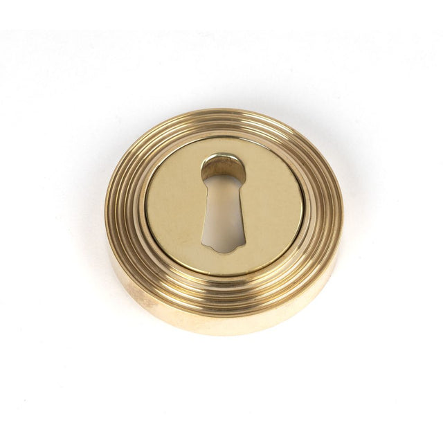 This is an image of From The Anvil - Polished Brass Round Escutcheon (Beehive) available to order from T.H Wiggans Architectural Ironmongery in Kendal, quick delivery and discounted prices.