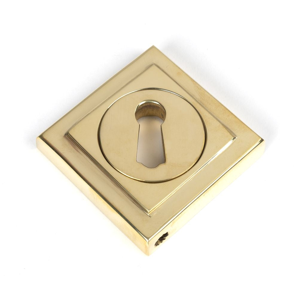 This is an image showing From The Anvil - Polished Brass Round Escutcheon (Square) available from trade door handles, quick delivery and discounted prices