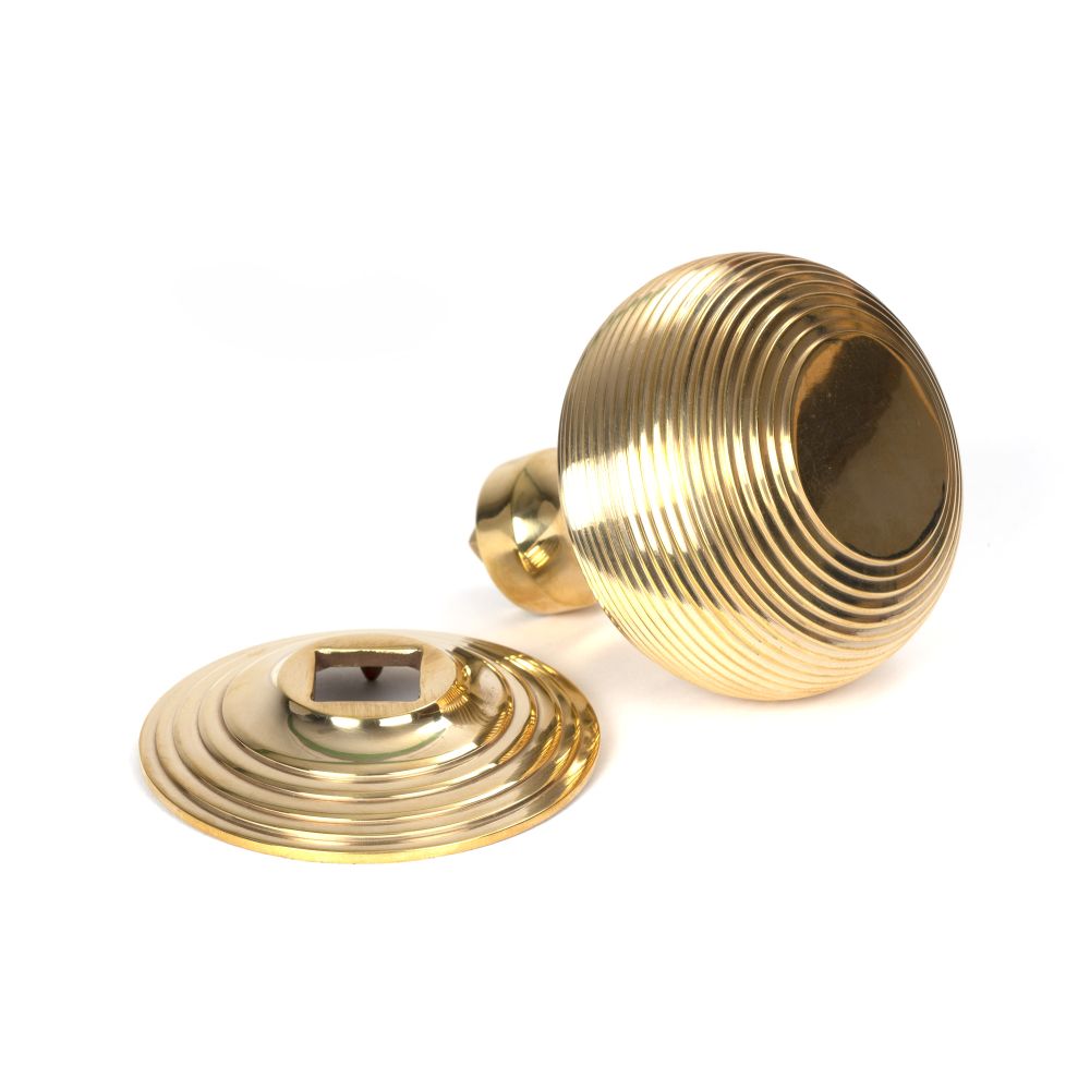 This is an image showing From The Anvil - Polished Brass Beehive Centre Door Knob available from trade door handles, quick delivery and discounted prices