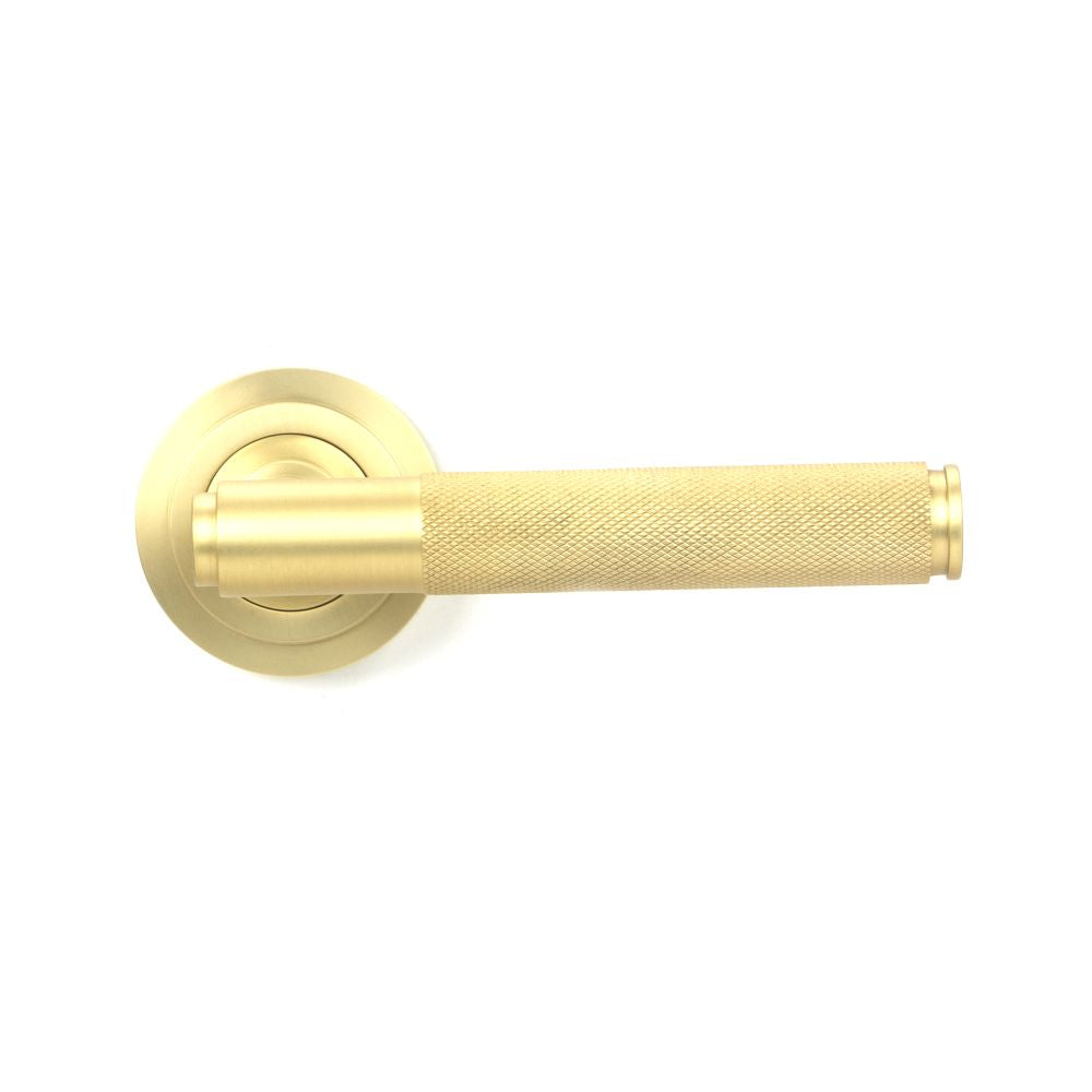 This is an image showing From The Anvil - Satin Brass Brompton Lever on Rose Set (Art Deco) available from trade door handles, quick delivery and discounted prices
