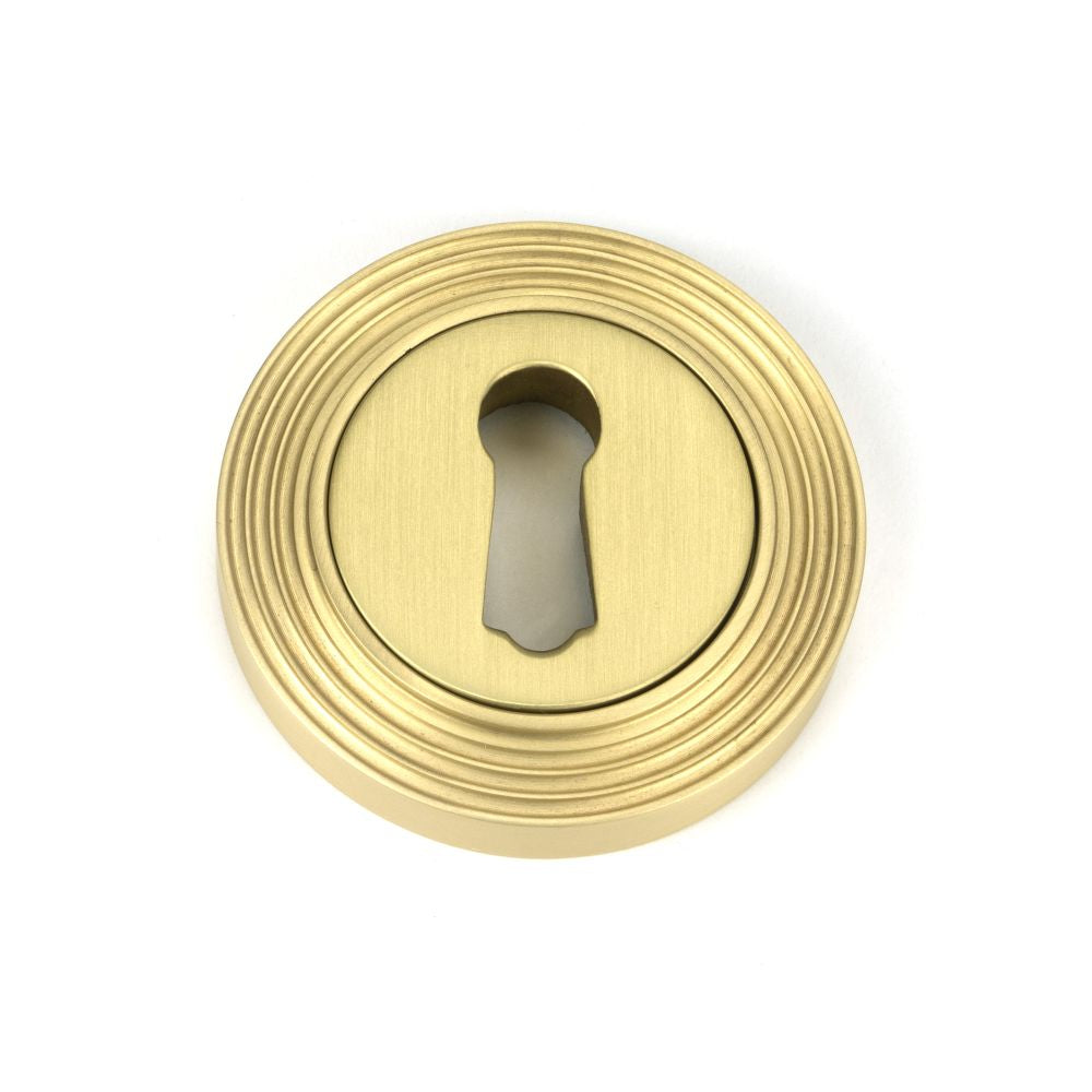 This is an image of From The Anvil - Satin Brass Round Escutcheon (Beehive) available to order from T.H Wiggans Architectural Ironmongery in Kendal, quick delivery and discounted prices.