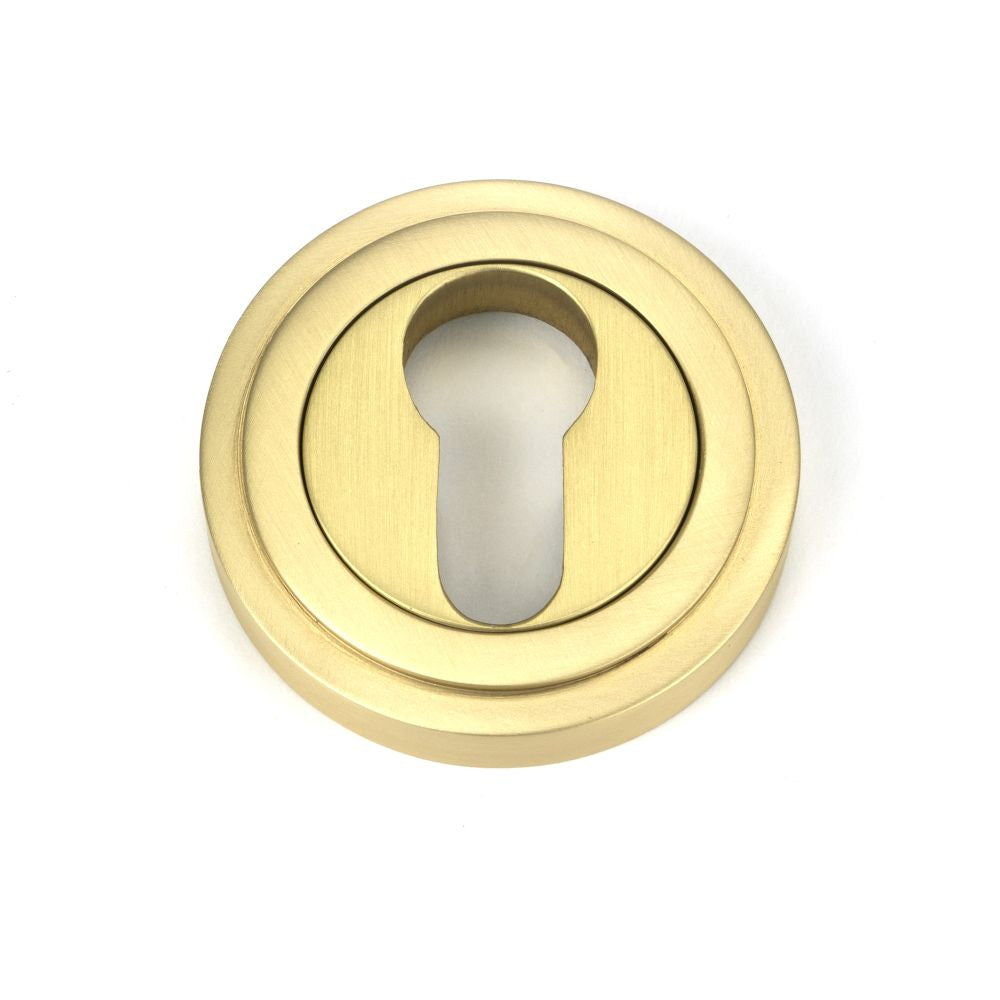 This is an image of From The Anvil - Satin Brass Round Euro Escutcheon (Art Deco) available to order from T.H Wiggans Architectural Ironmongery in Kendal, quick delivery and discounted prices.