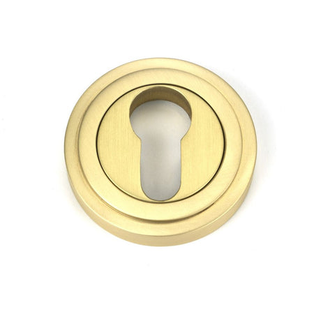 This is an image of From The Anvil - Satin Brass Round Euro Escutcheon (Art Deco) available to order from T.H Wiggans Architectural Ironmongery in Kendal, quick delivery and discounted prices.