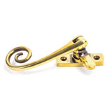 This is an image showing From The Anvil - Aged Brass Monkeytail Fastener available from T.H Wiggans Architectural Ironmongery in Kendal, quick delivery and discounted prices