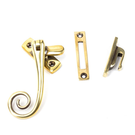 This is an image showing From The Anvil - Aged Brass Monkeytail Fastener available from T.H Wiggans Architectural Ironmongery in Kendal, quick delivery and discounted prices