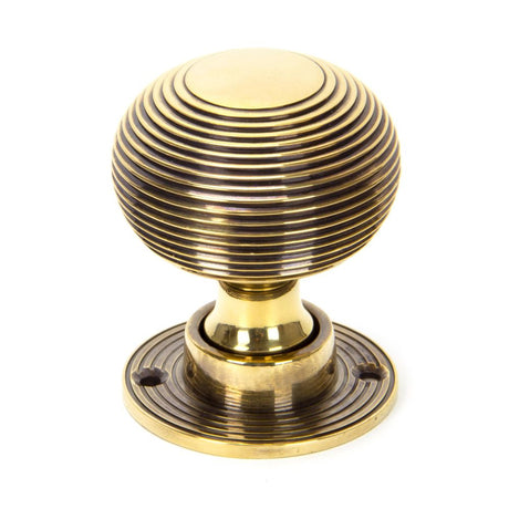 This is an image showing From The Anvil - Aged Brass Heavy Beehive Mortice/Rim Knob Set available from trade door handles, quick delivery and discounted prices