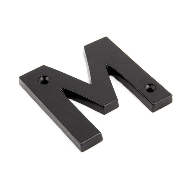 This is an image of From The Anvil - Black Letter M available to order from T.H Wiggans Architectural Ironmongery in Kendal, quick delivery and discounted prices.