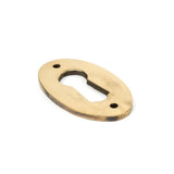 This is an image of From The Anvil - Aged Brass Oval Escutcheon available to order from T.H Wiggans Architectural Ironmongery in Kendal, quick delivery and discounted prices.