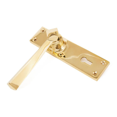 This is an image showing From The Anvil - Polished Brass Straight Lever Lock Set available from trade door handles, quick delivery and discounted prices