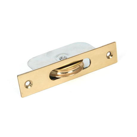 This is an image showing From The Anvil - Lacquered Brass Square Ended Sash Pulley 75kg available from T.H Wiggans Architectural Ironmongery in Kendal, quick delivery and discounted prices