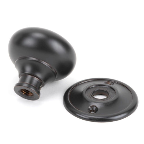 This is an image showing From The Anvil - Aged Bronze Mushroom Mortice/Rim Knob Set available from trade door handles, quick delivery and discounted prices