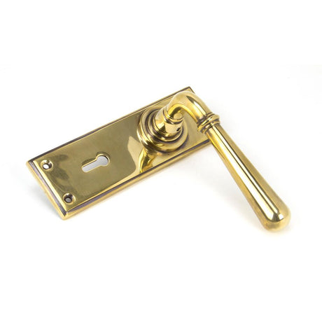 This is an image showing From The Anvil - Aged Brass Newbury Lever Lock Set available from trade door handles, quick delivery and discounted prices