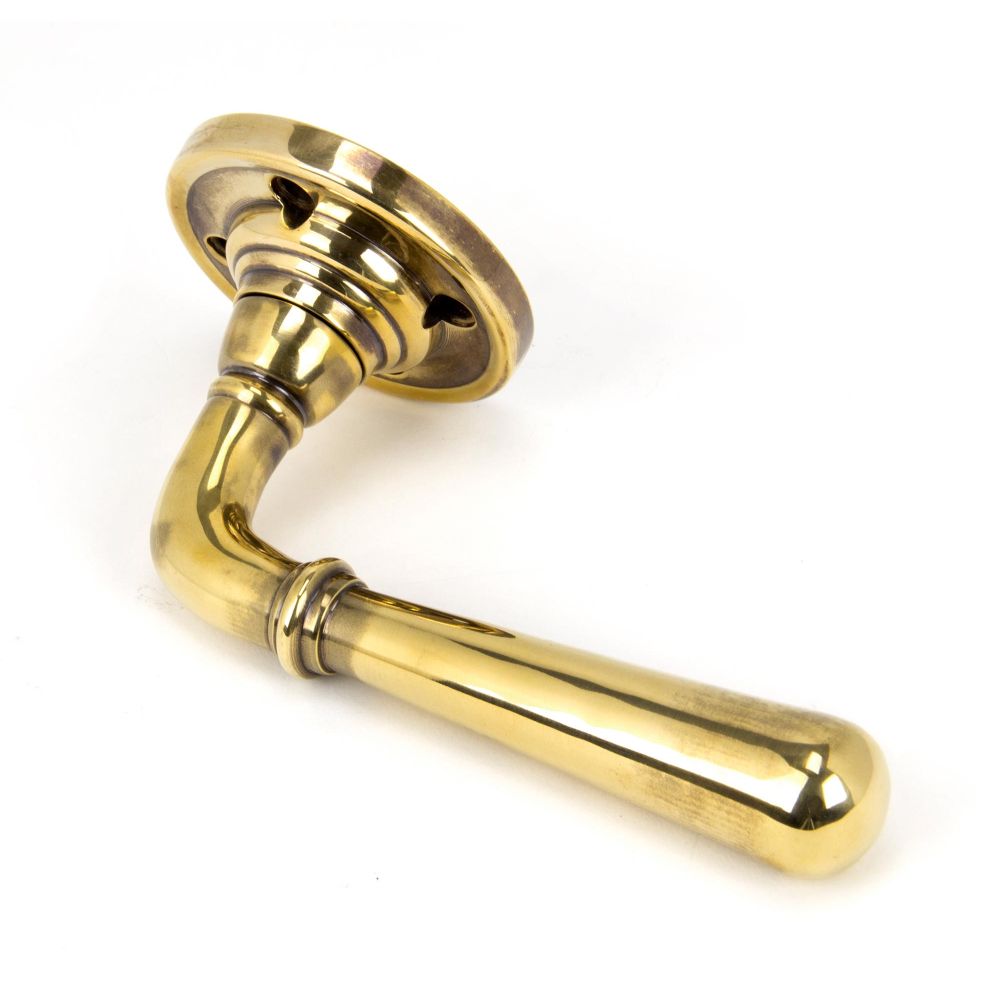 This is an image showing From The Anvil - Aged Brass Newbury Lever on Rose Set available from trade door handles, quick delivery and discounted prices