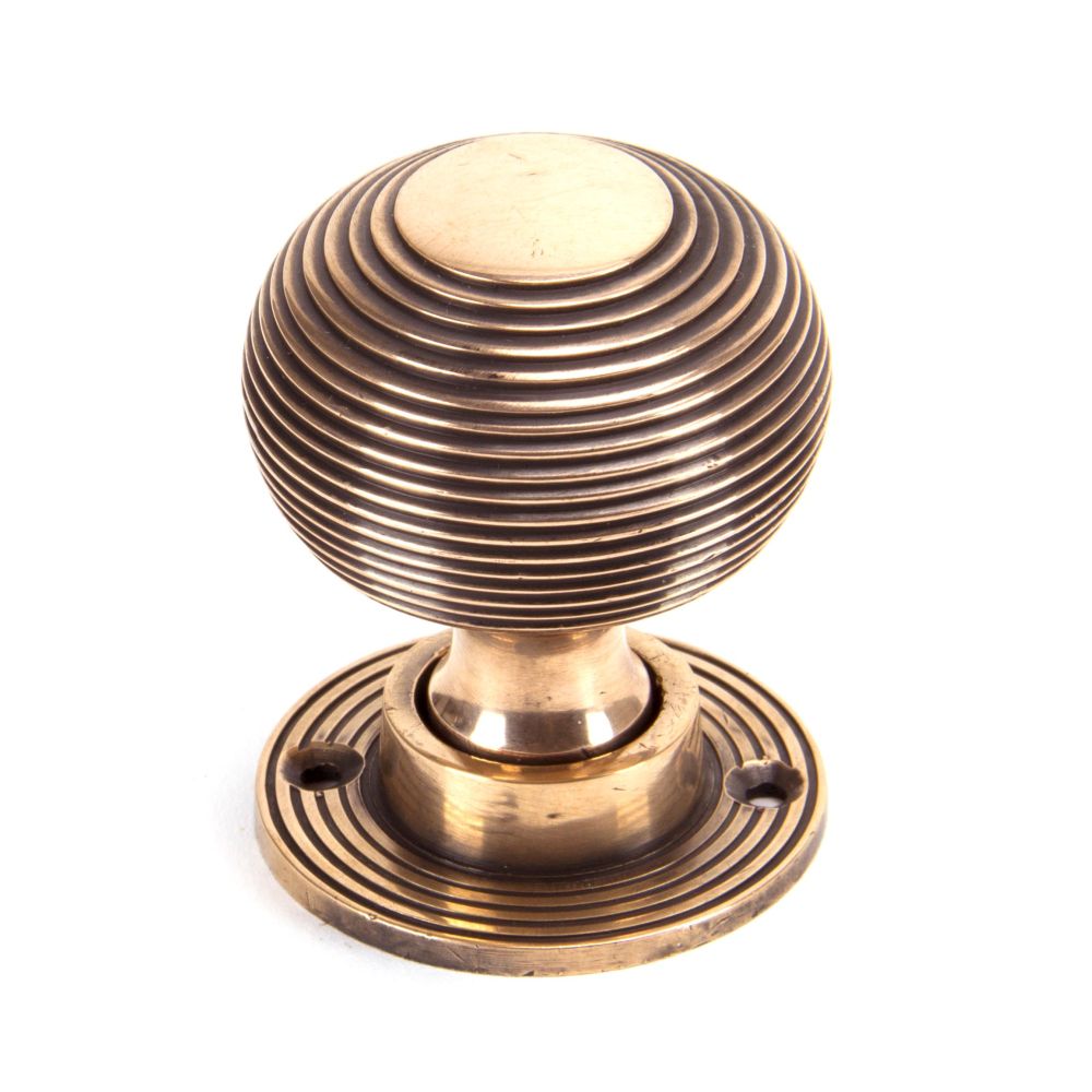 This is an image showing From The Anvil - Polished Bronze Heavy Beehive Mortice/Rim Knob Set available from trade door handles, quick delivery and discounted prices