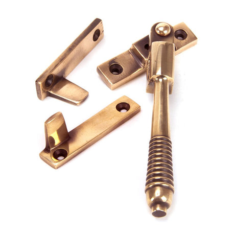 This is an image showing From The Anvil - Polished Bronze Night-Vent Locking Reeded Fastener available from T.H Wiggans Architectural Ironmongery in Kendal, quick delivery and discounted prices