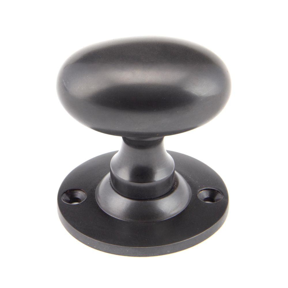 This is an image showing From The Anvil - Aged Bronze Oval Mortice/Rim Knob Set available from trade door handles, quick delivery and discounted prices