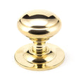 This is an image of From The Anvil - Polished Brass Round Centre Door Knob available to order from T.H Wiggans Architectural Ironmongery in Kendal, quick delivery and discounted prices.