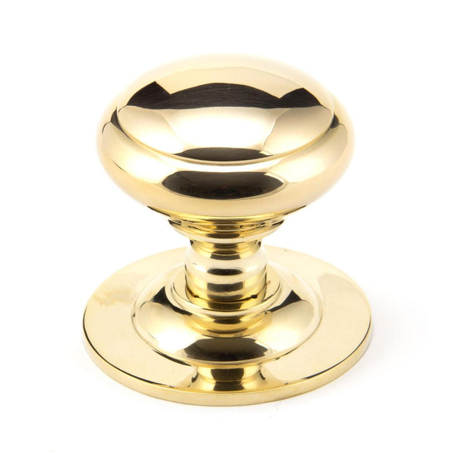 This is an image of From The Anvil - Polished Brass Round Centre Door Knob available to order from T.H Wiggans Architectural Ironmongery in Kendal, quick delivery and discounted prices.