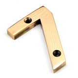 This is an image of From The Anvil - Polished Bronze Numeral 7 available to order from T.H Wiggans Architectural Ironmongery in Kendal, quick delivery and discounted prices.