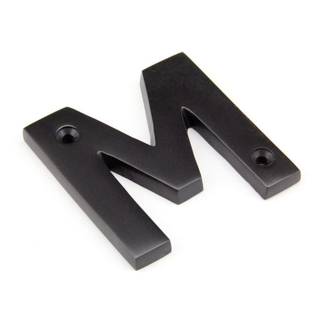 This is an image of From The Anvil - Aged Bronze Letter M available to order from T.H Wiggans Architectural Ironmongery in Kendal, quick delivery and discounted prices.