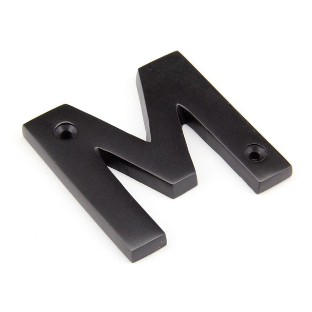 This is an image of From The Anvil - Aged Bronze Letter M available to order from T.H Wiggans Architectural Ironmongery in Kendal, quick delivery and discounted prices.