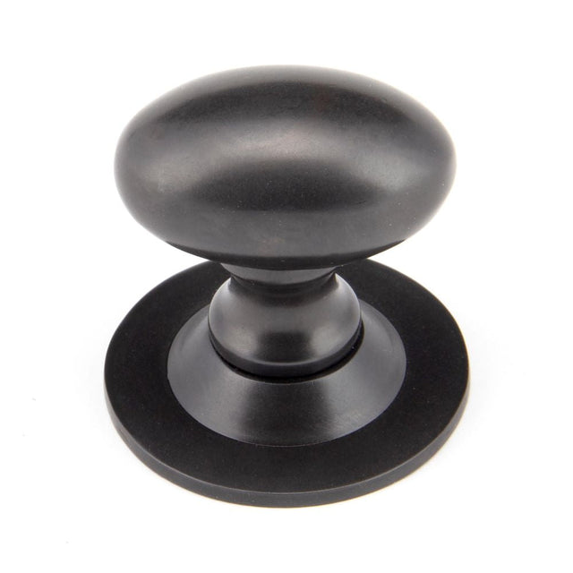 This is an image showing From The Anvil - Aged Bronze Oval Cabinet Knob 33mm available from T.H Wiggans Architectural Ironmongery in Kendal, quick delivery and discounted prices