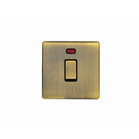 This is an image showing Eurolite Concealed 3mm 20Amp Switch with Neon Indicator - Antique Brass (With Black Trim) ab20adpswnb available to order from T.H. Wiggans Ironmongery in Kendal, quick delivery and discounted prices.