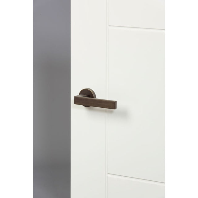 This is an image of Forme Asti Designer Lever on Minimal Round Rose - Urban Bronze available to order from T.H Wiggans Architectural Ironmongery in Kendal, quick delivery and discounted prices.