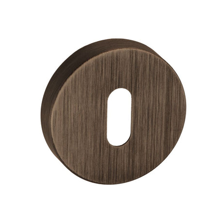 This is an image of Forme Key Escutcheon on Minimal Round Rose - Urban Bronze available to order from T.H Wiggans Architectural Ironmongery in Kendal, quick delivery and discounted prices.