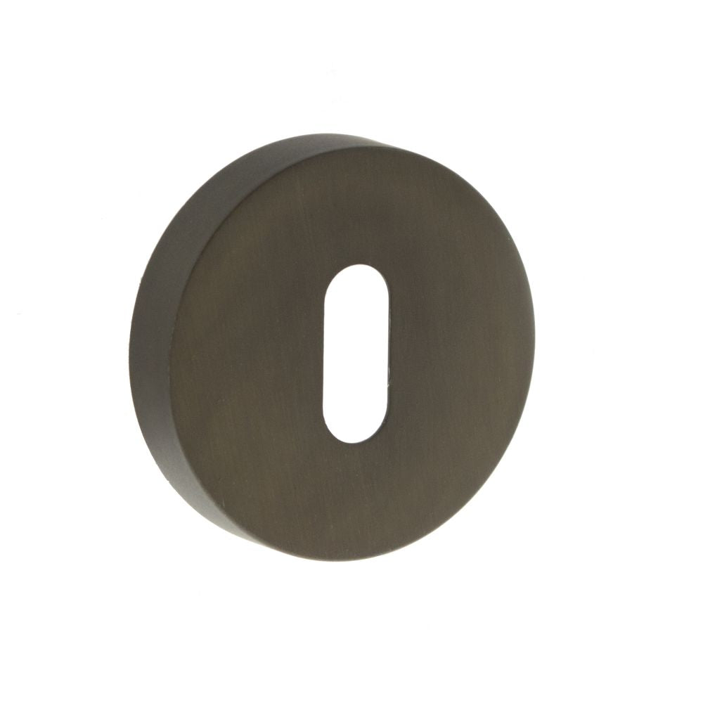 This is an image of Forme Key Escutcheon on Minimal Round Rose - Urban Dark Bronze available to order from T.H Wiggans Architectural Ironmongery in Kendal, quick delivery and discounted prices.